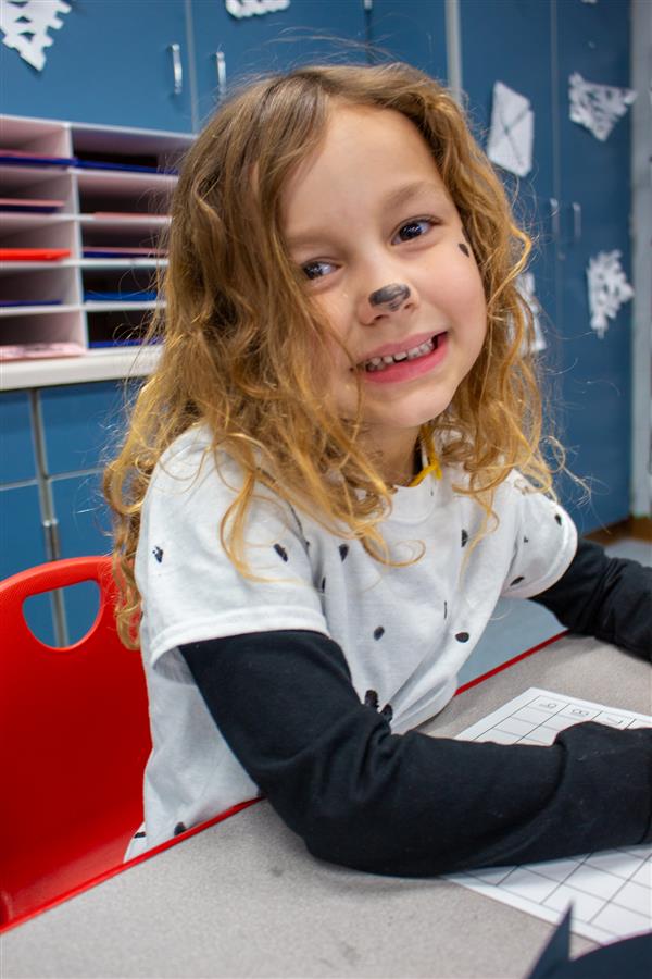 girl smiling dressed as dalmatian dog